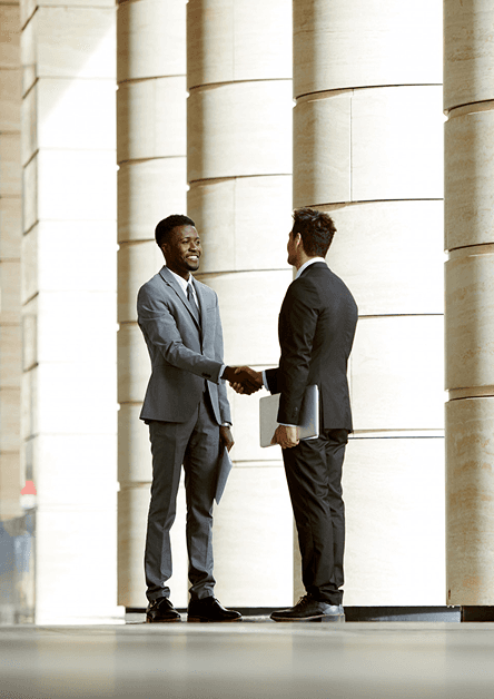 Business professionals shaking hands in modern office
